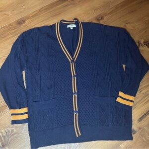 Virgo’s cable knit navy and gold cardigan